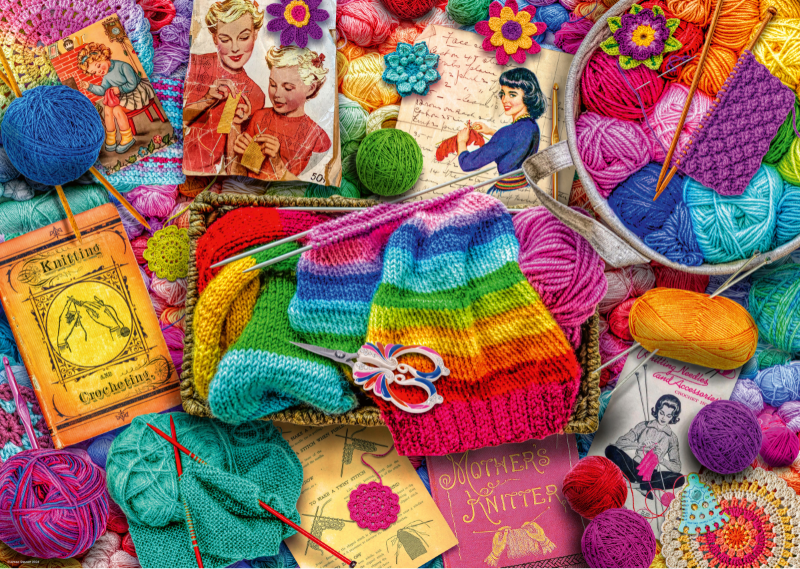Colorful knitting supplies including yarn, needles, and knitted items on a white background.