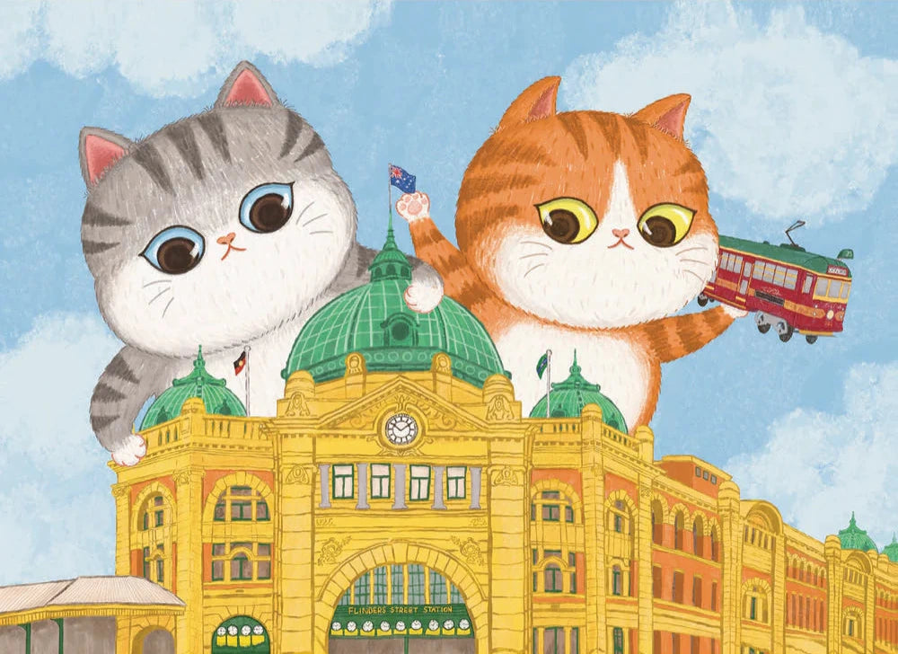 Two cartoon cats on top of Flinders Street Station with a blue sky background